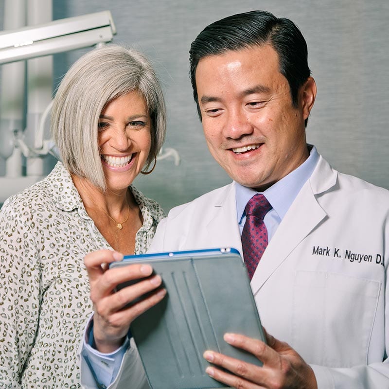 Doctor showing an image of a lady smile